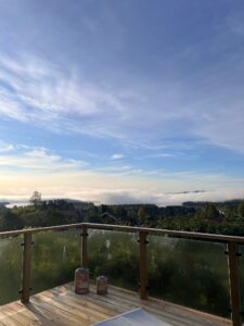 Corner-mounted deck balustrade with misty view Morning view from timber deck with corner glass balustrade, overlooking misty landscape and adding stylish outdoor safety.