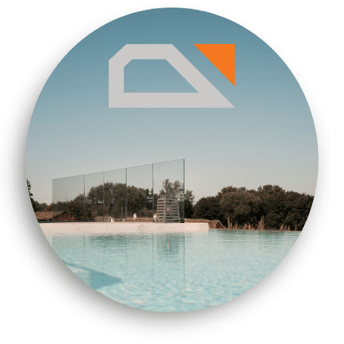 Still pool with a glass windbreak in the background, mounted with clamps and offering a clear view of trees and sky on a calm day.