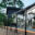 Black Glass Balustrade for Modern Terrace Matte black balustrade with clear safety glass fitted on raised patio next to contemporary home with outdoor seating area.
