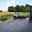 Stainless Steel Wire Railing with Countryside View Sleek horizontal wire balustrade on grey deck with lounge area and panoramic views over meadows and private gardens.